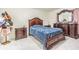 Elegant bedroom with tiled floors and dark-stained, ornate bedroom furniture set at 9031 Westchester Cir # 128, Tampa, FL 33604