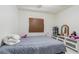 Bedroom featuring a bed, window with roller shade and white walls at 9031 Westchester Cir # 128, Tampa, FL 33604