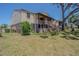 Exterior of townhomes with outdoor stairs, patios, and grassy common area at 9031 Westchester Cir # 128, Tampa, FL 33604