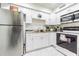 Modern kitchen with white cabinets, stainless steel appliances, and marble floors at 9031 Westchester Cir # 128, Tampa, FL 33604