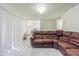 Inviting living room area featuring a leather sofa, neutral walls and bright marble floors at 9031 Westchester Cir # 128, Tampa, FL 33604