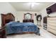 Spacious main bedroom with tiled floors, dresser and large decorative wood bedframe at 9031 Westchester Cir # 128, Tampa, FL 33604