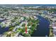 Waterfront community view showcases a home on a canal with lush greenery and ample boating access at 9265 Treasure Ln Ne, St Petersburg, FL 33702