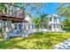 A beautiful backyard with a deck, covered picnic table, and lush lawn at 9265 Treasure Ln Ne, St Petersburg, FL 33702