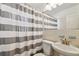 Cozy bathroom with a sink, toilet, and tiled shower, perfect for everyday use at 9265 Treasure Ln Ne, St Petersburg, FL 33702