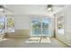Bedroom with balcony access, offering a view of the canal at 9265 Treasure Ln Ne, St Petersburg, FL 33702
