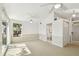 Airy bedroom featuring plush carpeting, a ceiling fan, and an attached bathroom at 9265 Treasure Ln Ne, St Petersburg, FL 33702