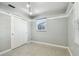 Neutral bedroom featuring gray walls, ceiling track lighting, and one window at 9265 Treasure Ln Ne, St Petersburg, FL 33702