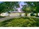 Charming home with a well-manicured lawn and mature trees providing shade and curb appeal at 9265 Treasure Ln Ne, St Petersburg, FL 33702