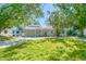 Charming home with a well-manicured lawn and lush landscaping, showcasing curb appeal at 9265 Treasure Ln Ne, St Petersburg, FL 33702