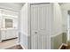Hallway featuring wood flooring and a linen closet, next to a bathroom at 9265 Treasure Ln Ne, St Petersburg, FL 33702