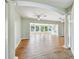 Expansive living area with hardwood floors, columns, and large windows offering water views at 9265 Treasure Ln Ne, St Petersburg, FL 33702