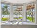 Close up on a bay window with a waterfront view and light filtering blinds at 9265 Treasure Ln Ne, St Petersburg, FL 33702