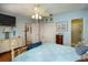 Bright bedroom with hardwood floors, a ceiling fan, and a view to the bathroom at 930 S Lyndhurst St, Dunedin, FL 34698