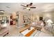 Spacious living room boasts neutral décor, tile flooring, comfortable seating, and an open layout to the kitchen at 930 S Lyndhurst St, Dunedin, FL 34698