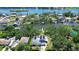 Panoramic aerial view of a home, showcasing solar panels and its prime waterfront location with lush landscaping at 9303 Alice Ln, Riverview, FL 33578