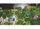 Expansive aerial view of the property featuring a swimming pool, lush greenery, and waterfront access with a private dock at 9303 Alice Ln, Riverview, FL 33578