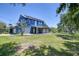 Beautiful backyard featuring a covered porch and gazebo, perfect for outdoor entertaining and enjoying the scenic waterfront view at 9303 Alice Ln, Riverview, FL 33578