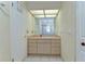 The bathroom has a single sink and a big mirror above a cabinet with lots of storage space at 9303 Alice Ln, Riverview, FL 33578