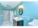Bathroom has blue walls, white tile flooring and a shower with curtain at 9303 Alice Ln, Riverview, FL 33578