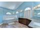Modern bathroom with a soaking tub, dual sinks, and granite countertops at 9303 Alice Ln, Riverview, FL 33578
