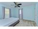 The bedroom is brightly colored and has a ceiling fan and two windows at 9303 Alice Ln, Riverview, FL 33578