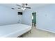 Bedroom features a ceiling fan, a TV, and an ensuite bath at 9303 Alice Ln, Riverview, FL 33578