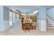Bright dining area with tile floors, wood table and bench seating, with kitchen and patio access at 9303 Alice Ln, Riverview, FL 33578