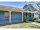 Charming home with a covered front porch with craftsman columns, brick accents, and lush landscaping for curb appeal at 9303 Alice Ln, Riverview, FL 33578