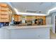 A well-lit kitchen with light wood cabinets, stainless steel appliances, and tiled backsplash at 9303 Alice Ln, Riverview, FL 33578