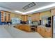 Spacious kitchen with light wood cabinetry, tile backsplash, and stainless steel appliances at 9303 Alice Ln, Riverview, FL 33578