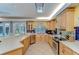 Bright kitchen featuring wooden cabinets, stainless steel appliances, and tile flooring at 9303 Alice Ln, Riverview, FL 33578
