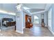 A bedroom with an office space, wood floors, and large windows with plantation shutters at 9303 Alice Ln, Riverview, FL 33578