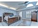 This main bedroom features light blue walls, wood flooring, and a ceiling fan at 9303 Alice Ln, Riverview, FL 33578