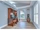 Bright office space with wood floors, desk, and a decorative window with plantation shutters at 9303 Alice Ln, Riverview, FL 33578