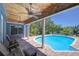 Enjoy the pool area with wood ceiling, brick patio, and outdoor seating at 9303 Alice Ln, Riverview, FL 33578