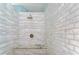 Modern shower with neutral tiling and built-in bench, creating a spa-like experience at 9303 Alice Ln, Riverview, FL 33578