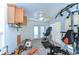 Sunroom with tile floors, garden equipment, and exercise equipment at 9303 Alice Ln, Riverview, FL 33578