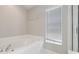 A soothing bathroom showcasing a modern soaking tub next to a window and a glass-enclosed shower at 944 Ridge Haven Dr, Brandon, FL 33511