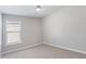 Bright bedroom featuring neutral walls, a window, and plush carpeting, perfect for relaxation at 944 Ridge Haven Dr, Brandon, FL 33511