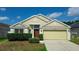 Inviting single-story home with a well-manicured front yard, featuring a two-car garage and lush greenery at 944 Ridge Haven Dr, Brandon, FL 33511