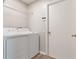 Bright laundry room features a modern washer and dryer, plus convenient overhead shelving for storage at 944 Ridge Haven Dr, Brandon, FL 33511