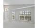 Bright and spacious living room featuring large windows, neutral carpet, and vaulted ceilings at 944 Ridge Haven Dr, Brandon, FL 33511