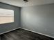Well-lit bedroom featuring hardwood floors and a window with blinds for privacy at 1010 Lochmont Dr, Brandon, FL 33511