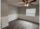 Bright bedroom with wood-look floors, neutral paint, and a large window with blinds at 1010 Lochmont Dr, Brandon, FL 33511