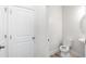 Bright half-bathroom featuring a white toilet and neutral decor at 10127 Newel Valley Loop, Riverview, FL 33569