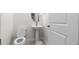 Bright half-bathroom featuring a pedestal sink and a white toilet at 10127 Newel Valley Loop, Riverview, FL 33569