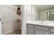 Bathroom featuring single sink vanity, gray cabinets, and walk-in closet at 10127 Newel Valley Loop, Riverview, FL 33569