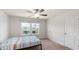 Bright bedroom with a ceiling fan and two windows for ample natural light at 10127 Newel Valley Loop, Riverview, FL 33569