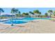 Sparkling community pool featuring a zero entry section, sun loungers and nearby umbrellas at 10127 Newel Valley Loop, Riverview, FL 33569